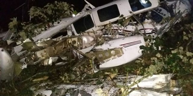 This photo released by the San Predro de los Milagros Fire Department shows the wreckage of a small plane assigned to the crew of a film starring Tom Cruise, that crashed, in a rural place of San Pedro de los Milagros, Colombia, Friday, Sept. 11, 2015. The country's civilian aviation authority said the twin-engine Aerostar crashed Friday after taking off from a small colonial town near Medellin, killing two people, including a Los Angeles-based film pilot, and seriously injuring a third. (San Pedro de los Milagros Fire Department via AP)