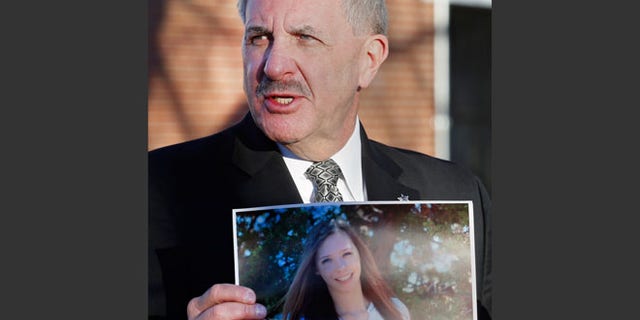 Dec. 14, 2013: Arapahoe County Sheriff Grayson Robinson holds a picture of Claire Davis, the 17-year-old student who was shot in the head by a classmate, during a briefing at Arapahoe High School in Centennial, Colo.