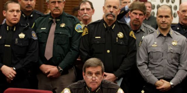 March 4, 2013: Weld County Sheriff John Cooke, center, backed by a group of fellow sheriffs, testifies against proposed gun control legislation in the Colorado Legislature, at the State Capitol, in Denver.