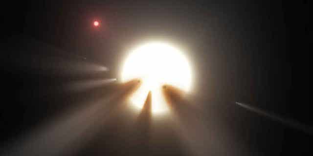 This artist's illustration shows comet fragments crossing the face of a star, one possible explanation for the strange dimming exhibited by "Boyajian's star."
