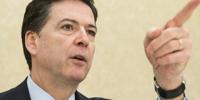 FBI Director James B. Comey takes a question during a news conference on the release of the 9/11 Review Commission report in Washington March 25, 2015. The FBI needs to strengthen its intelligence programs and information sharing to counter the diverse and fast-moving national threats that have evolved since the Sept. 11, 2001, attacks, the congressional commission said on Wednesday. REUTERS/Joshua Roberts