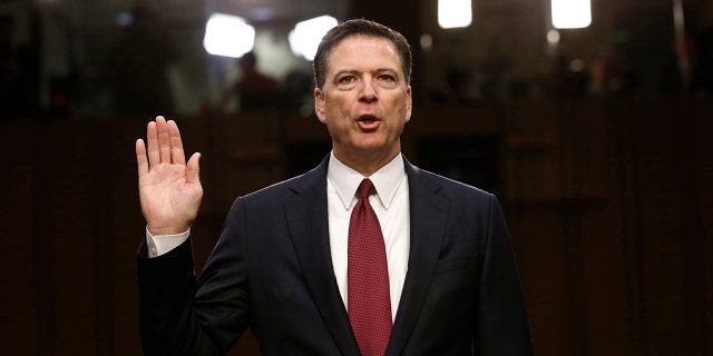 Former FBI Director James Comey is sworn in prior to testifying before a Senate Intelligence Committee hearing on Russia's alleged interference in the 2016 U.S. presidential election on Capitol Hill in Washington, U.S., June 8, 2017.