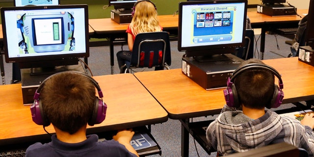 July 21, 2014: Students at a summer reading academy at Buchanan elementary school work in the computer lab at the school in Oklahoma City. Results for some of the states that participated in Common Core-aligned testing for the first time this spring are out, with overall scores higher than expected though still below what many parents may be accustomed to seeing.