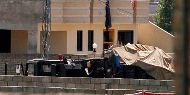 Vehicles are parked inside the compound of a house where it is believed Usama bin Laden lived in Abbottabad, Pakistan, May 2.