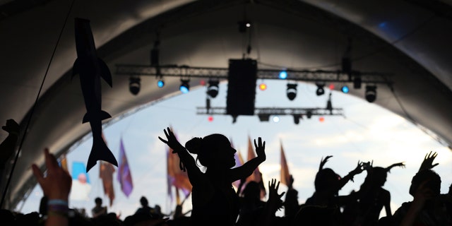 Festival goers dance during the Glastonbury Festival June 28, 2014.