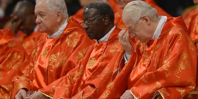 Senegalese cardinal Theodore-Adrien Sarr (C) and Italian cardinal Angelo Scola (R) were served simple meals during their deliberation over the next Pope.