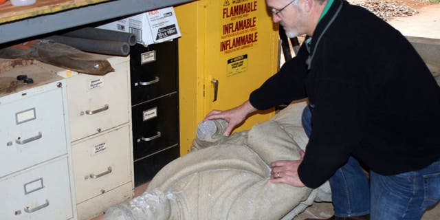 Crews investigated the damage to the statue.