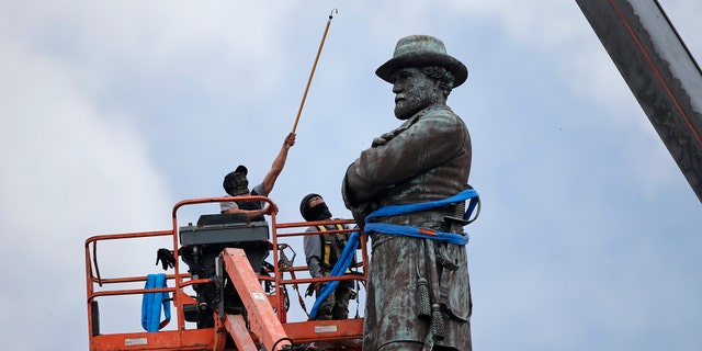 n this Friday, May 19, 2017, file photo, workers prepare to take down the statue of former Confederate Gen. Robert E. Lee, which stands over 100 feet tall, in Lee Circle in New Orleans.