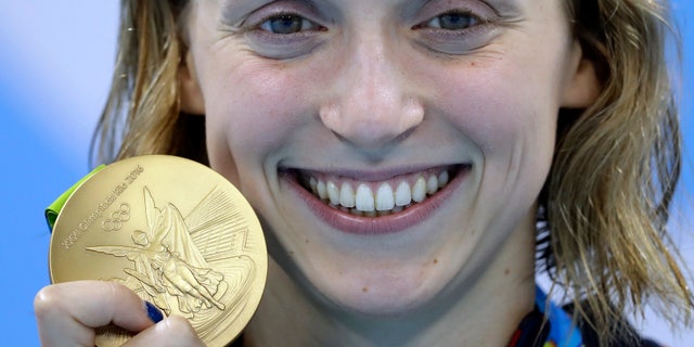 Aug. 12, 2016: United States' Katie Ledecky shows off her gold medal in the women's 800-meter freestyle medals ceremony during the swimming competitions at the 2016 Summer Olympics in Rio de Janeiro, Brazil.