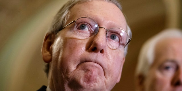 Dec. 2, 2014: Senate Minority Leader Mitch McConnell of Ky., accompanied by Senate Minority Whip John Cornyn of Texas, speaks with reporters following a closed-door policy meeting at the Capitol in Washington