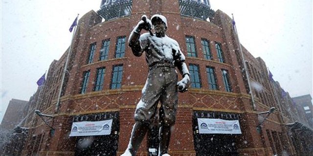 A statue of Branch Rickey is covered in snow outside of Coors Field before a baseball game between the New York Mets and the Colorado Rockies, Monday, April 15, 2013, in Denver. The game has been postponed by a heavy spring snowstorm. The teams will play a split-doubleheader Tuesday. (AP Photo/Jack Dempsey)