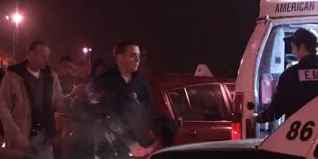 Police remove a 2-year-old child from a car in a K-Mart parking lot.