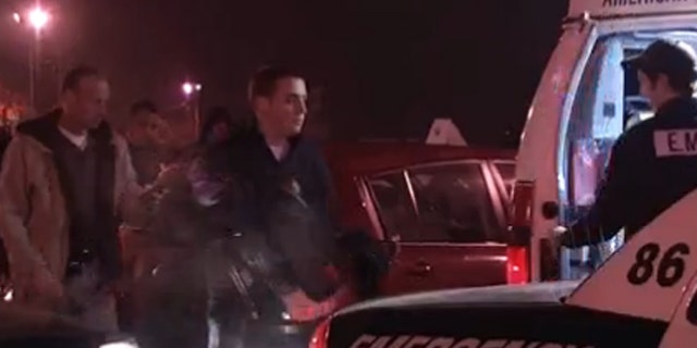 Police remove a 2-year-old child from a car in a K-Mart parking lot.