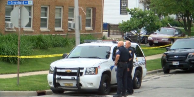 Officers stand outside Adam Trammell's apartment on May 25, 2017.