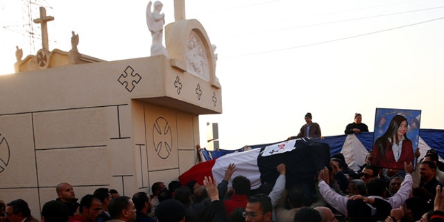 The body of one of the victims from Sunday’s bombing of Cairo’s main Coptic Cathedral is carried to be buried at the Mokattam Cemetery.
