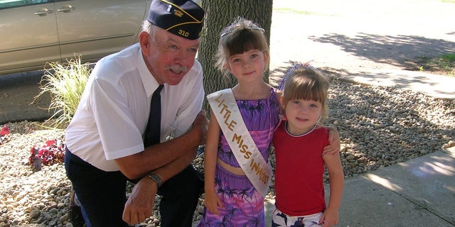 Paul and his granddaughters on the day of a Fourth of July parade.