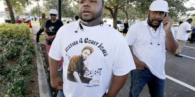 Tim Kitchens, a cousin of Corey Jones, at a rally in October.