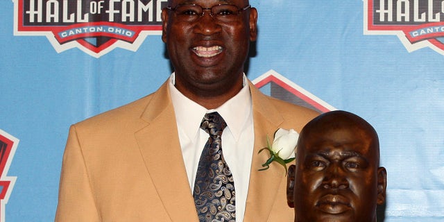 Former Seattle Seahawk Cortez Kennedy stands with his bust after being accepted into the Pro Football Hall of Fame in Canton, Ohio August 4, 2012. Kennedy was found dead on Tuesday in Orlando. REUTERS/Aaron Josefczyk