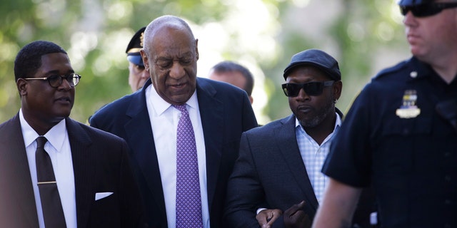 Bill Cosby arrives with Comedian Joe Torry, second from right, for his sexual assault trial at the Montgomery County Courthouse in Norristown, Pa., Friday, June 9, 2017.
