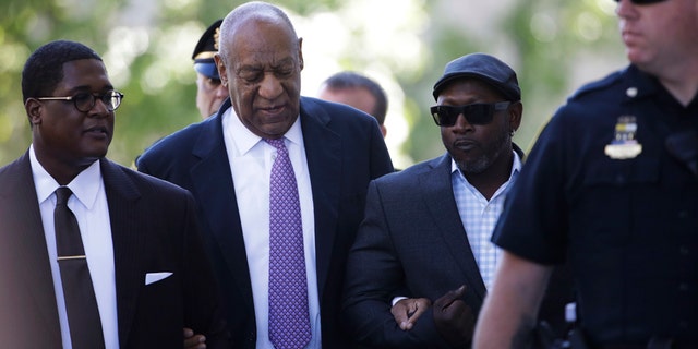 Bill Cosby arrives with Comedian Joe Torry, second from right, for his sexual assault trial at the Montgomery County Courthouse in Norristown, Pa., Friday, June 9, 2017.