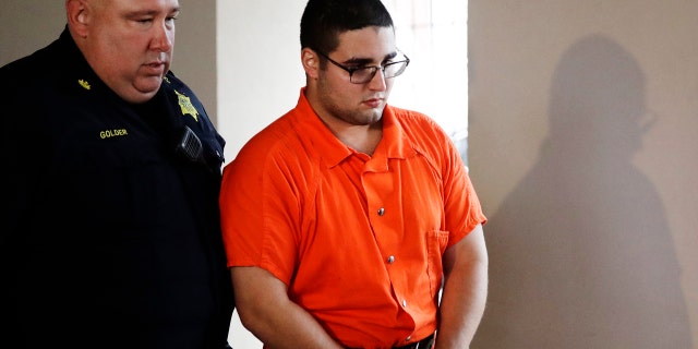 In this July 13, 2017 file photo, a law enforcement official escorts Cosmo DiNardo to a vehicle in, Doylestown, Pa.