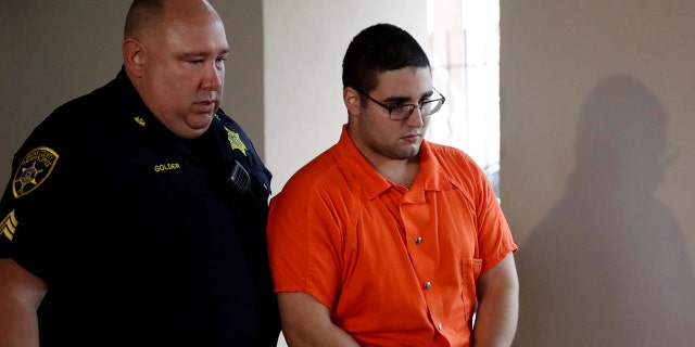 A law enforcement official escorts Cosmo DiNardo to a vehicle Thursday, July 13, 2017, in Doylestown, Pa.