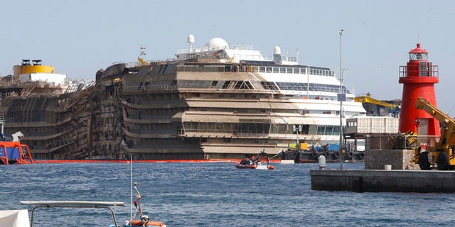 Sept. 17, 2013: The cruise liner Costa Concordia is seen at the end of the "parbuckling" operation outside Giglio harbor. Salvage crews completed raising the wreck of the Costa Concordia in the early hours of Tuesday morning after a 19-hour-long operation on the Italian island of Giglio where the huge cruise liner capsized in January last year.
