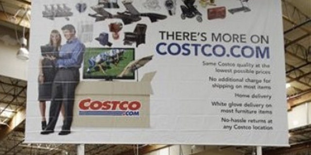 In this June 17, 2011, photo, a hot tub is on display in front of advertising for online service Costco.com at Costco in Mountain View, Calif. Costco has spent $2.3 million on an initiative that would privatize liquor sales in the state.