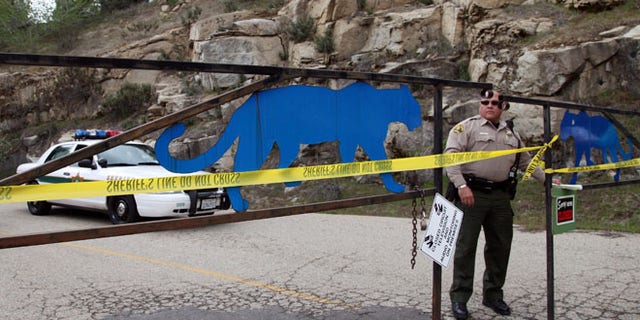 March 6, 2013: An officer guards the gate near at the entrance of Cat Haven, the exotic animal park in central California, where a 26-year-old female volunteer intern was killed by a lion, in Dunlap, Calif.
