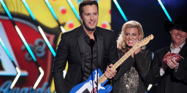 Dec. 10, 2013: Luke Bryan accepts the male artist of the year award onstage at the American Country Awards at the Mandalay Bay Resort & Casino in Las Vegas, Nev.