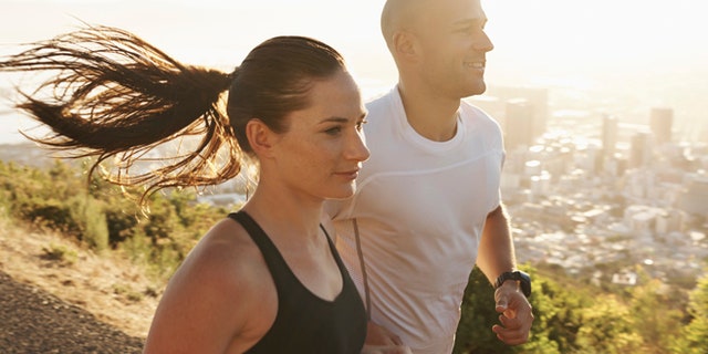 Shot of two young athletes training outdoors