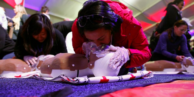 People learn CPR as part of a National Day of Service event on the National Mall in Washington D.C. January 19, 2013. REUTERS/Eric Thayer