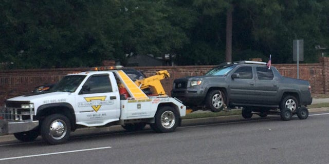 Mon. 11, 2015: A truck is towed at the scene of a shooting involving George Zimmerman near Trailhead Park in Lake Mary, Fla. (AP)
