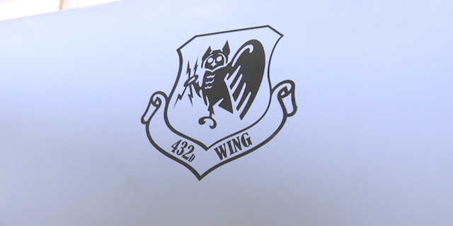 The logo of the 432nd Air Expeditionary Wing is emblazoned on the side of the MQ-9 Reaper