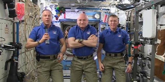 Astronauts Scott Kelly and Tim Kopra of NASA, and Tim Peake of the European Space Agency delivered a holiday message from the International Space Station on Dec. 18. The station Christmas tree can be seen just to the right of Kopra's head.