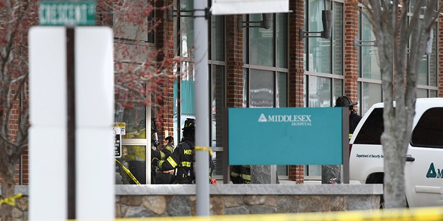 Responders investigating the scene of the car crash at Middlesex Hospital.