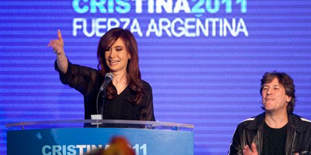 Argentina's President and candidate for re-election Cristina Fernandez, left, and Amado Boudou, Argentina's Minister of Economy and vice-presidential candidate, celebrate with supporters after the primary elections in Buenos Aires, Argentina, Sunday Aug. 14, 2011.