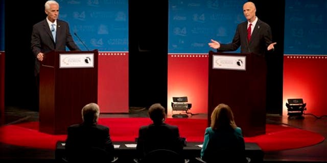 Oct. 15, 2014: Democratic challenger, former Republican Gov. Charlie Crist, left, and Florida Republican Gov. Rick Scott, answer questions during their second debate.