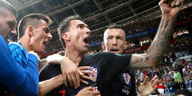 Croatia's Mario Mandzukic, center, celebrates after scoring his side's second goal during the semifinal match between Croatia and England at the 2018 FIFA World Cup, in Moscow, July 11, 2018.