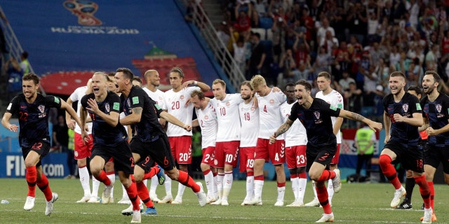 Croatia players run toward goalkeeper Danijel Subasic (not pictured) after the penalty shootout against Denmark.