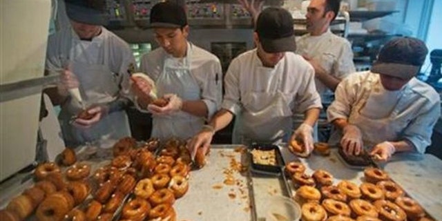 FILE: A baking crew makes Cronuts, a croissant-donut hybrid, at the Dominique Ansel Bakery in New York.