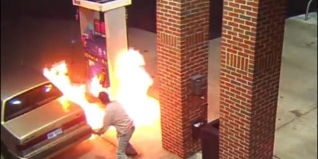 Image from surveillance video shows motorist starting gas station blaze trying to kill spider with lighter.