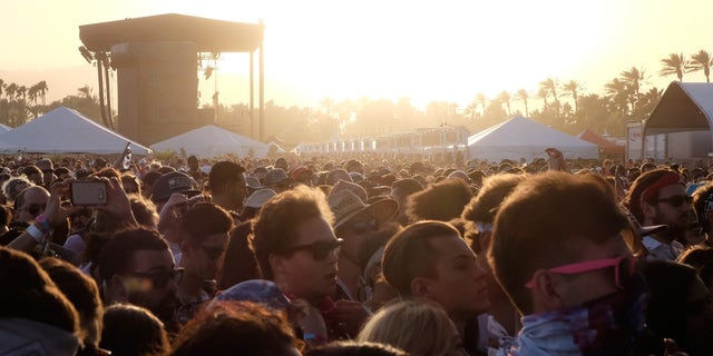 INDIO, CA - APRIL 15:  Festival goers at sunset during day 1 of the 2016 Coachella Valley Music &amp; Arts Festival Weekend 1 at the Empire Polo Club on April 15, 2016 in Indio, California.  (Photo by Frazer Harrison/Getty Images for Coachella)