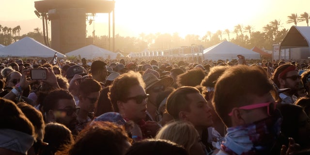 INDIO, CA - APRIL 15: Festival goers at sunset during day 1 of the 2016 Coachella Valley Music & Arts Festival Weekend 1 at the Empire Polo Club on April 15, 2016 in Indio, California. (Photo by Frazer Harrison/Getty Images for Coachella)