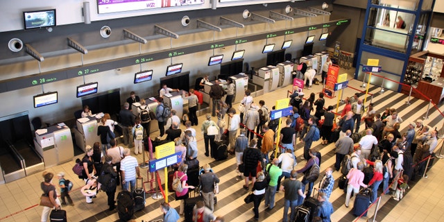 KATOWICE, POLAND - SEPTEMBER 1: Travelers wait for check-in on September 1, 2009 at Katowice Airport, Poland. With 2.366m passengers in 2010 it was the 3rd busiest airport in Poland.
