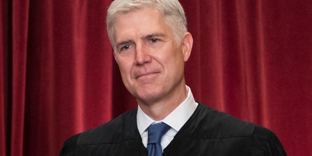 Associate Justice Neil Gorsuch joins other justices of the U.S. Supreme Court for an official group portrait at the Supreme Court Building in Washington, Thursday. June 1, 2017. Neil Gorsuch was nominated by President Donald Trump in 2017. (AP Photo/J. Scott Applewhite)