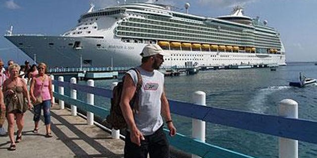 Cruise line passengers disembark for a shore visit.