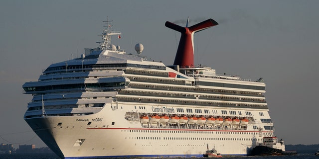 Feb. 14, 2013: In this file photo the cruise ship Carnival Triumph is towed into Mobile Bay near Dauphin Island, Ala.