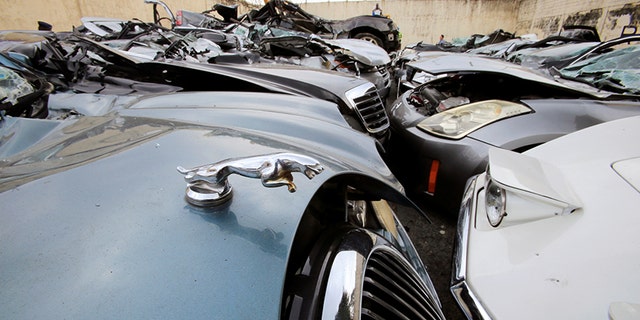 A classic Chevrolet Corvette and Jaguar sedan were among the wrecked cars.