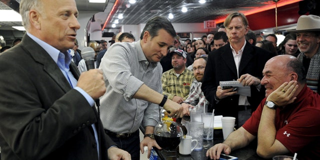 Jan. 4, 2016: U.S. Republican presidential candidate Ted Cruz (C) pours a supporter a cup of coffee during a campaign stop at Penny's Diner in Missouri Valley, Iowa.
